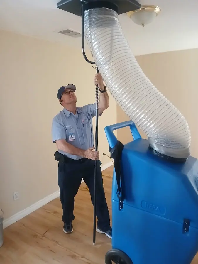 Furnace Tune-Up technician using HEPA equipment in Urbana